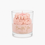 Beautiful You scented candle in soft pink with golden lettering, graceful whipped top and daisy on top.
