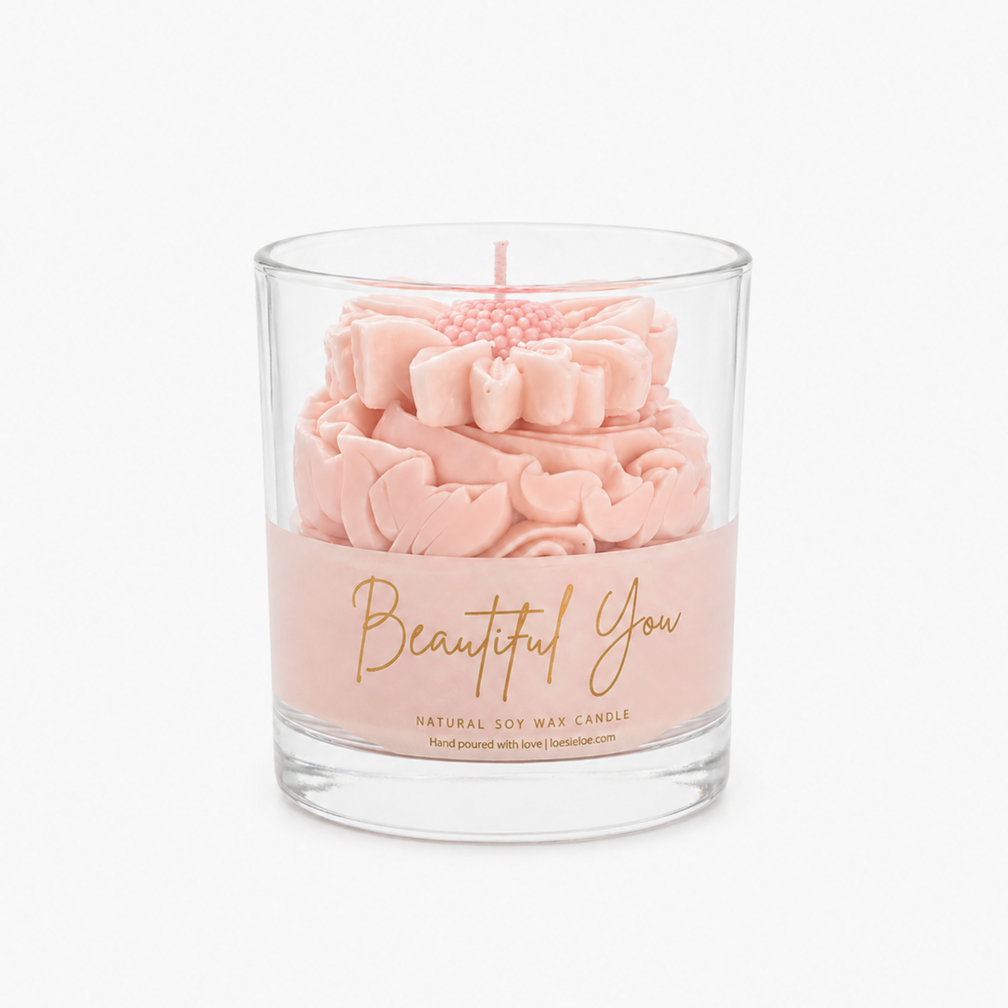 Beautiful You scented candle in soft pink with golden lettering, graceful whipped top and daisy on top.
