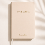 Homecoming notebook in A5 size with a soft cover, subtle golden details and ribbon bookmark.
